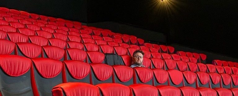 Joel Harley sitting in the cinema, watching a movie